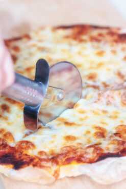 Slice of pizza with cutter