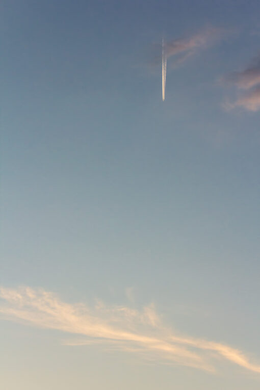 Airplane in the sky at sunset