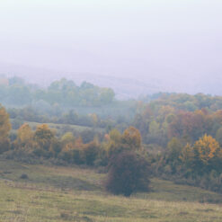 Fall landscape with haze over the hills