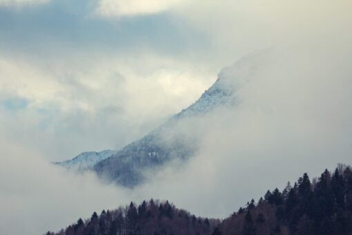 Mountain with trees and clouds